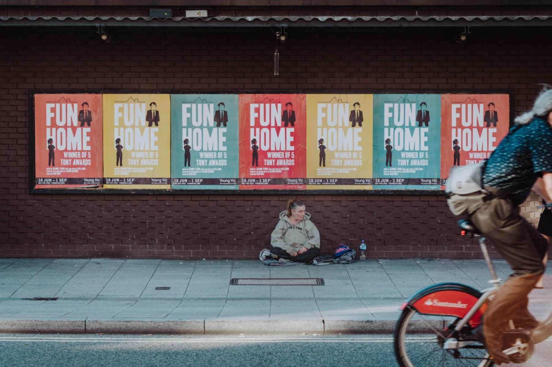 Picture of homeless person sitting on the street.